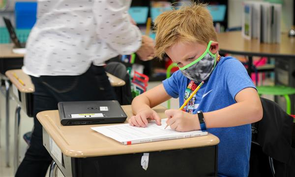 student works at desk